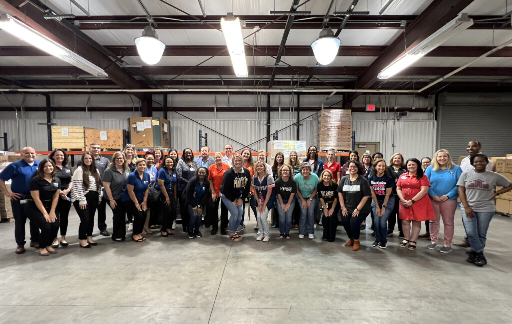 Conroe ISD counselors and staff joined by representatives from Entergy and United Way for delivery of school supplies at the South Warehouse.