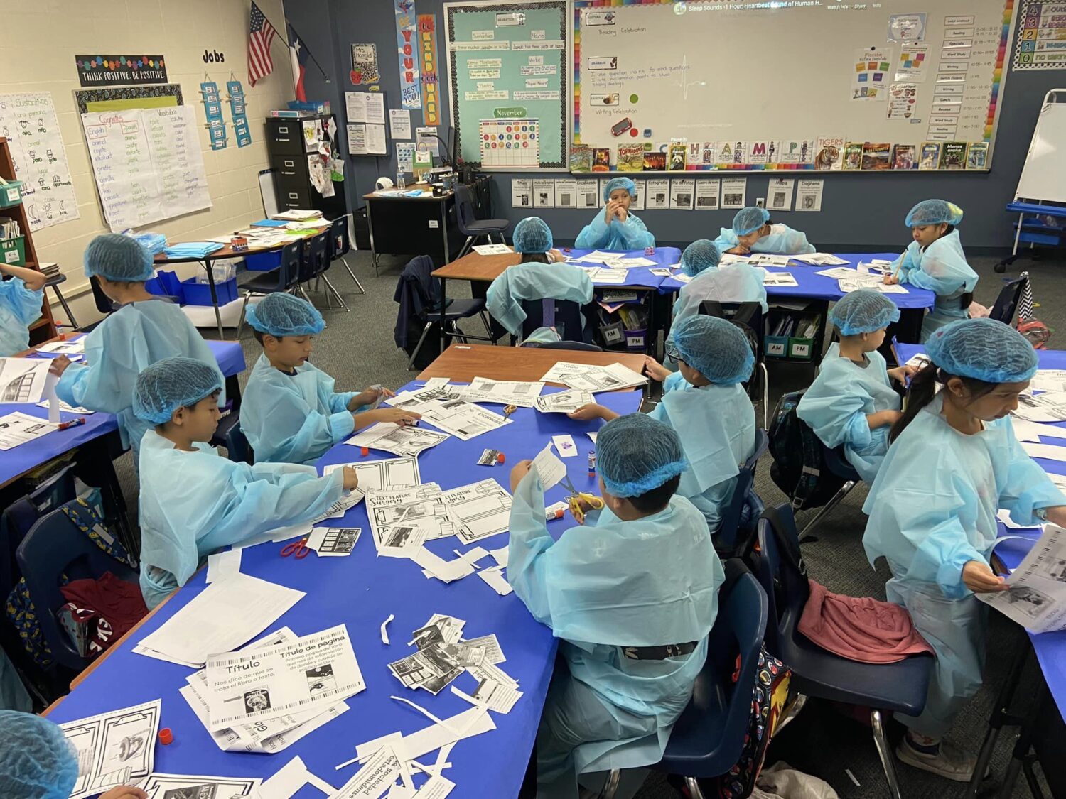 Students at Armstrong wear surgical attire as they "dissect" text in non-fiction books.